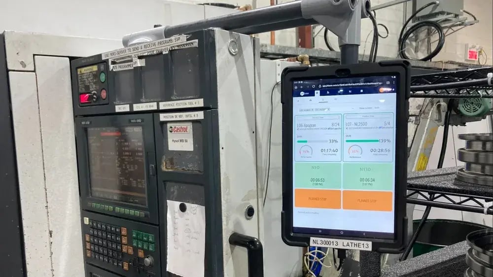 Tablet at a CNC lathe showing a planned stop: capturing downtime reasons for OEE with JITbase